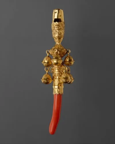 Teething coral with whistle and bells in gold.
