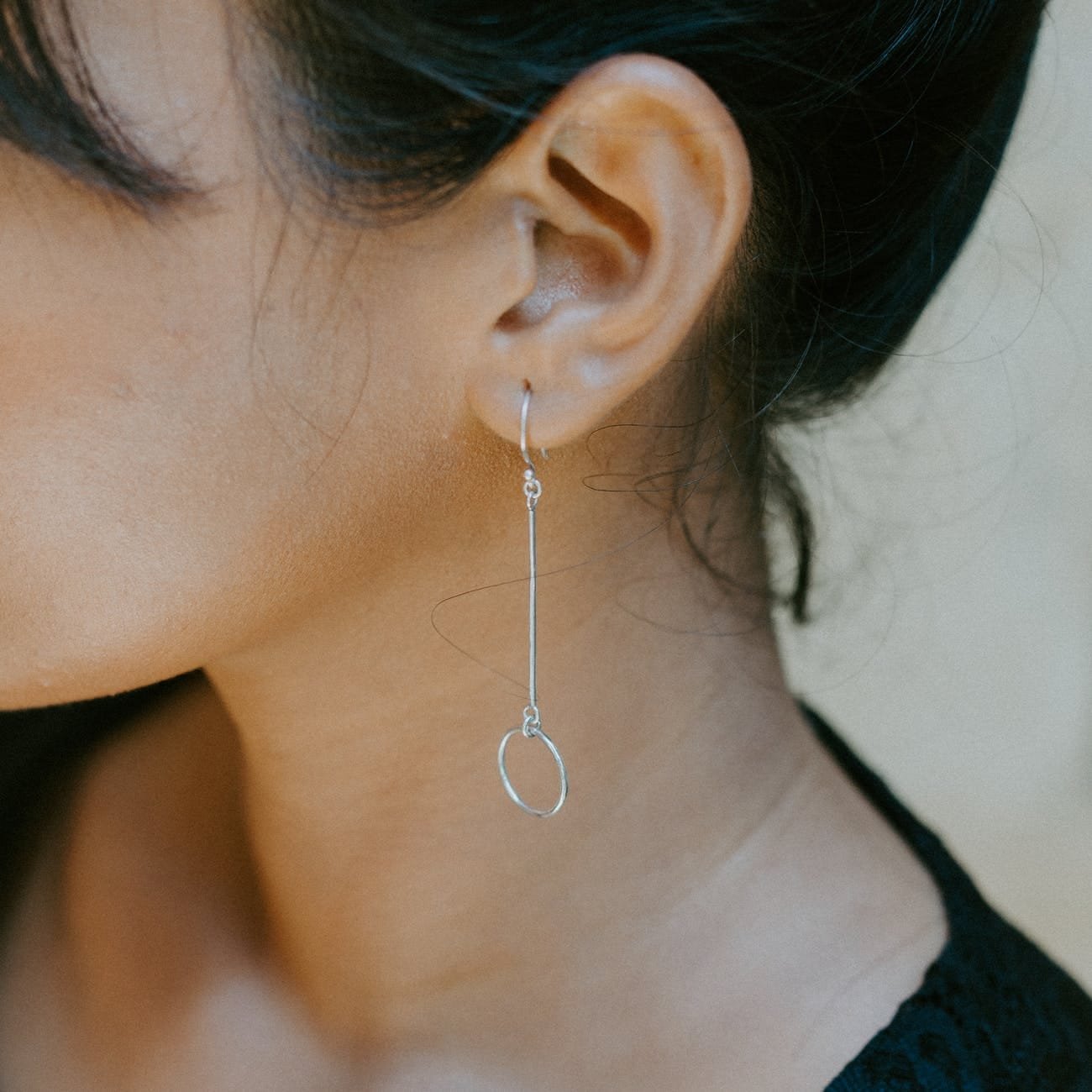 woman wearing silver colored earring