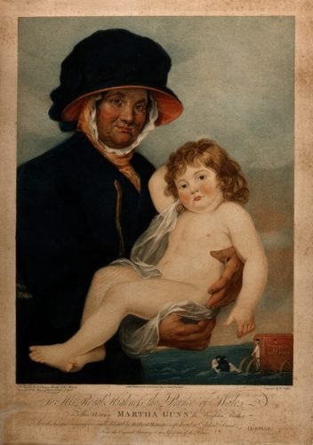 Martha Gunn, a Brighton bather holding a small child that she has just saved from drowning.