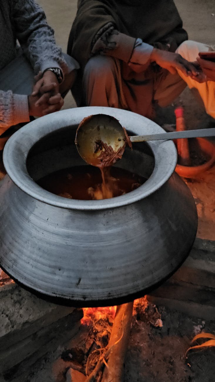 cooking in pot on bonfire